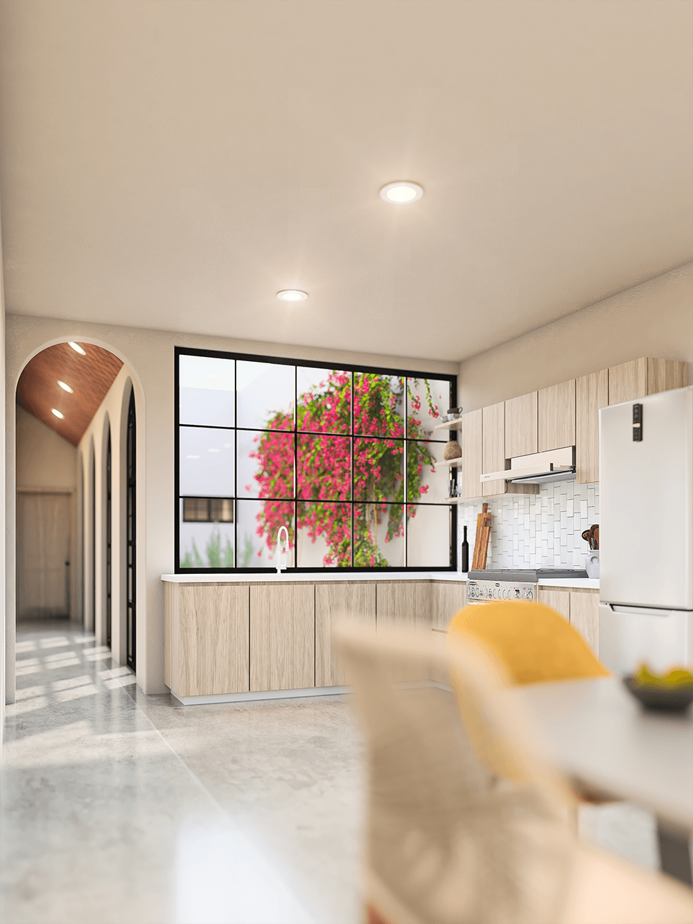 Casa Mariano kitchen with light wood cabinets and arched hallway